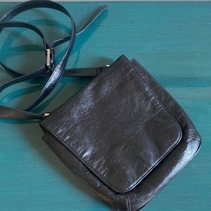 Hobo black leather cross body purse. Approximately 8” W x 7.5” H.
